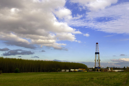 Oil rig, cloudy sky in the field 