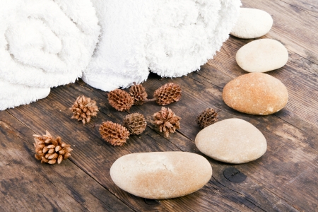 Towels and stones on the wooden floor の写真素材