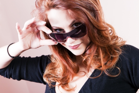 Beautiful young woman with sunglasses smiling の写真素材