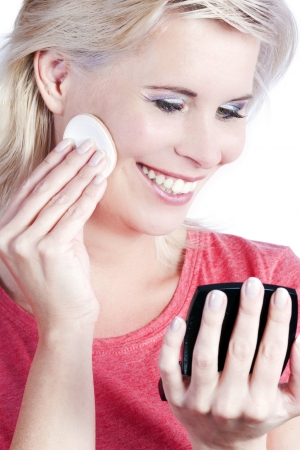 Young attractive woman wearing makeup itself の写真素材