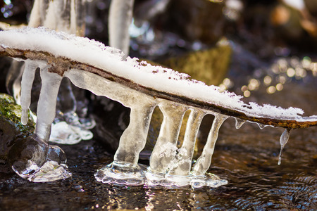 Frozen icicles above the river.の写真素材