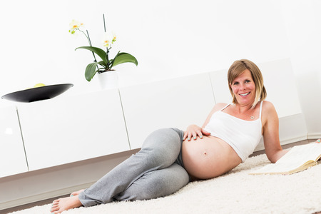 Pregnant woman resting at home.の写真素材
