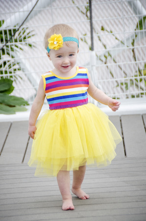 cute toddler in yellow tutuの写真素材