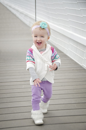 cute little toddler walking alongの写真素材
