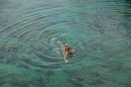 Father and daughter swimming in the natural swimming pool Charco De La Laja, at the north of Tenerife, Canary Islands, Spainの写真素材