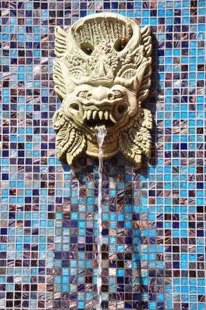 the Lion fountain on the wall slitting out waterの写真素材