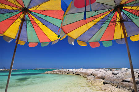The twin umbrella with beautiful beach and clear skyの写真素材