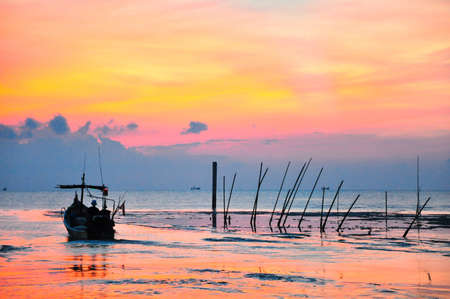 A fisherman sailing his boat during morningの写真素材