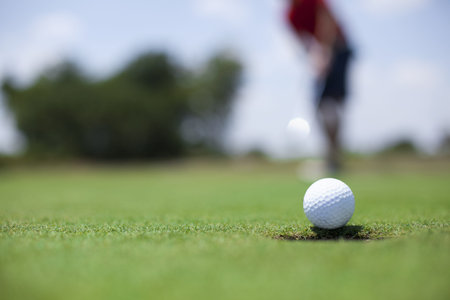 Man putting on the green with shallow depth of field. Room for copy. 
