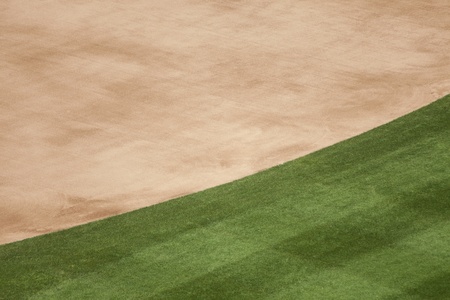 Background of the edge of the infield dirt and grass at a baseball