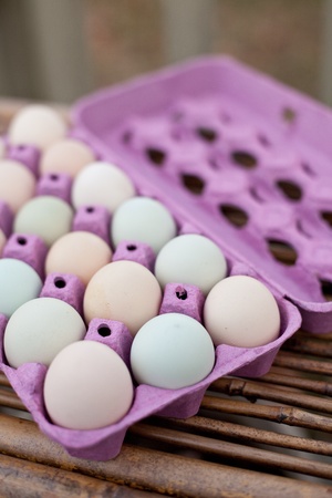 Open crate of colorful organic eggs.の写真素材