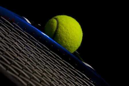 New tennis ball and racket isolated on black background  の写真素材