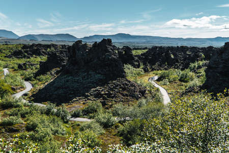 People Hiking on the Winding Trail Through the Dimmuborgir Lavaの写真素材