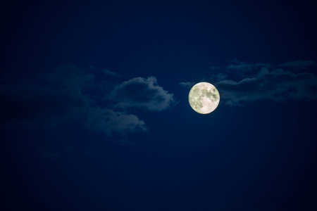 full moon in the night sky with clouds