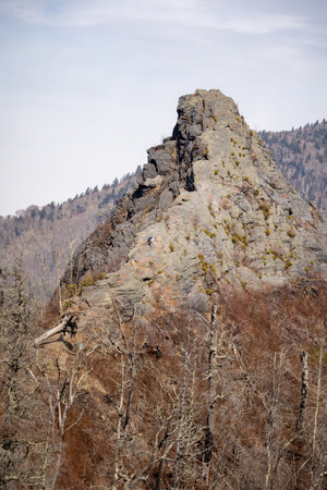 chimney tops with two people climbing the side of itの写真素材