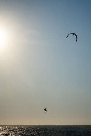 kite surfer catching air in the seaの写真素材