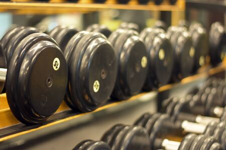 dumbbells in gym. Close up many dumbells in sport fitness centre.の写真素材