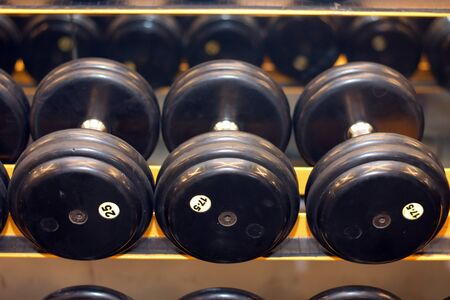 dumbbells in gym. Close up many dumbells in sport fitness centre.の写真素材