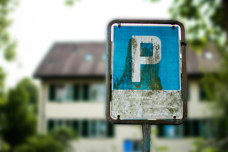 Blue metal parking lot sign with grunge old metal sign and letter p on a sign.の写真素材