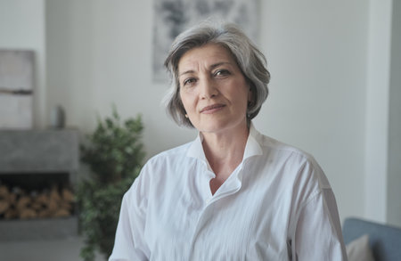 Strong senior mature old businesswoman looks seriously at the cameraの写真素材