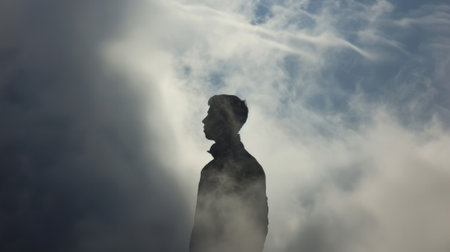 A mysterious silhouette enveloped in a cloudy embrace its shadow mirroring its every moveの素材