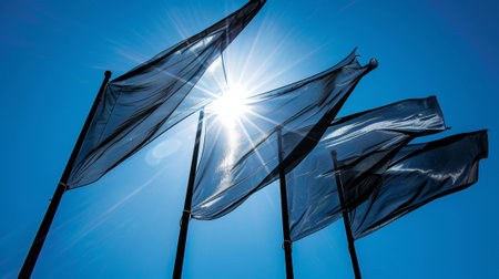 The flags crisp edges sharply contrasting with the blue sky behind itの素材