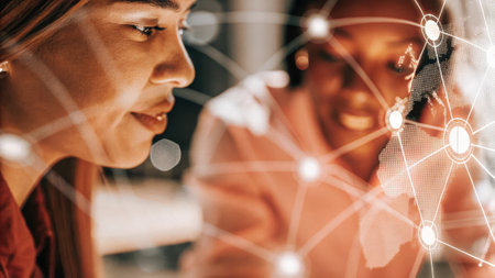 Closeup on a participant leaning in toward a hologram that visualizes a networking map with expressions of intrigue and contemplation on their faces..の素材