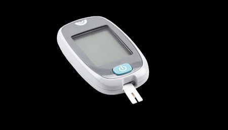 Closeup of a modern glucometer on a white background symbolizing blood sugar monitoring in managing diabetes risk after pancreatitis.の素材