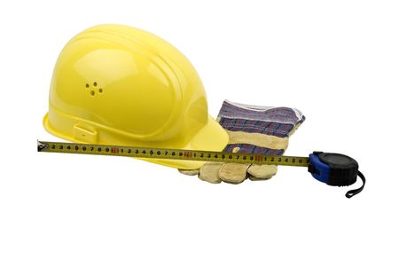 Yellow helmet,protective gloves and a measuring tape isolated on white backgroundの写真素材