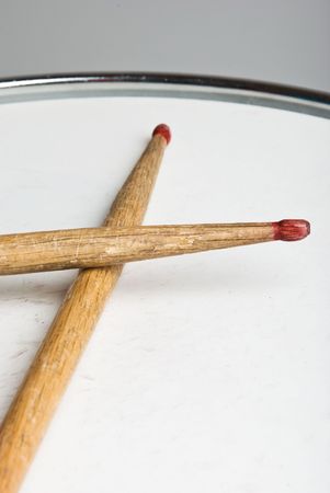 Close up of old wood drumsticks on a drum の写真素材