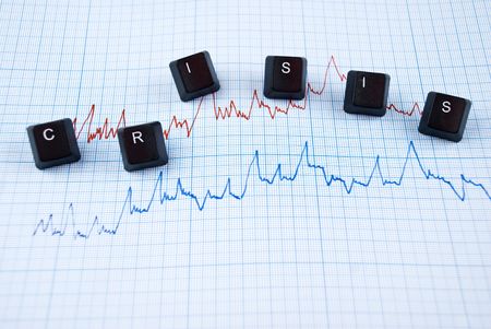 Financial crisis chart in two colors and word with letters of computer keyboardの写真素材