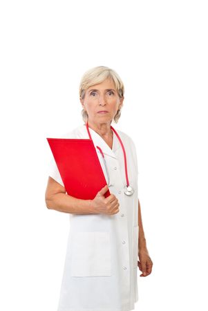 Serious aged docotr woman holding a red clipboard isolated on white backgroundの写真素材