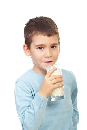 Preschool boy holding a glass with milk isolated on white backgroundの写真素材