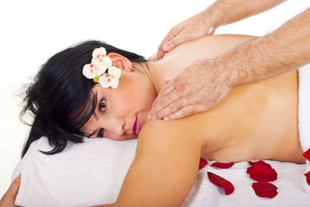Close up of a pretty woman getting back massage by a professional masseur man in a spa resortの写真素材