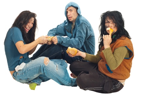 Hungry three beggars fight for a bread and sitting down isolated on white backgroundの写真素材