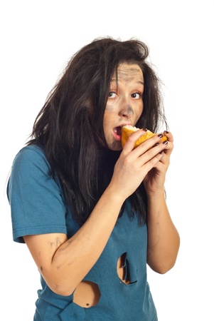 Beggar girl eating a peice of bread isolated on white backgroundの写真素材