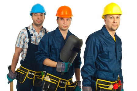 Teamwork of three builders men isolated on white backgroundの写真素材
