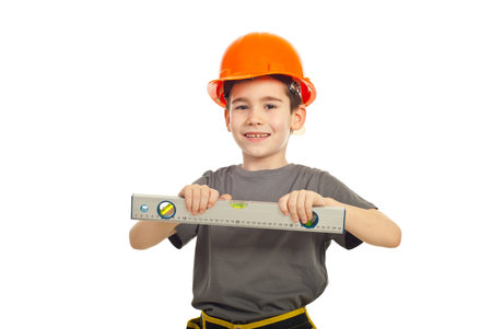 Smiling kid boy holding bubble level isolated on white background