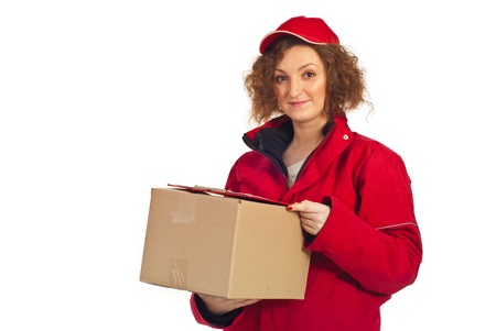Delivery woman in red cap and coat carrying box isolated on white backgroundの写真素材