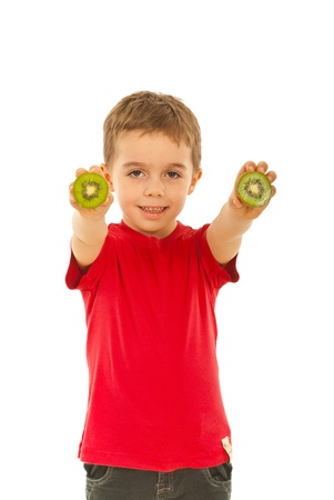 Happy boy in red t-shirt giving slices kiwi isolated on white backgroundの写真素材