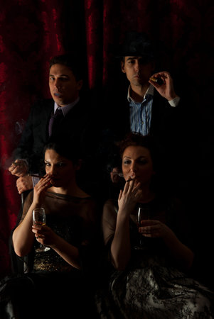 Retro two couples smoking in darkness and drinking wine