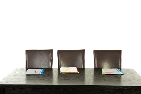 Empty chairs and table with folders andpencils isolated on white backgroundの写真素材