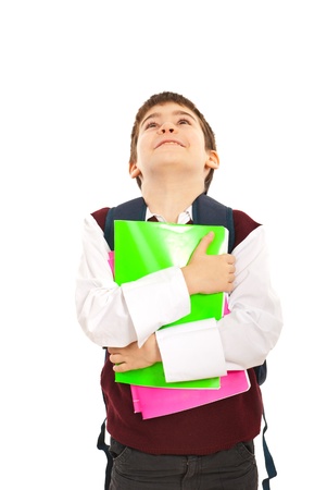 Schoolboy holding notebooks and looking upisolated on white backgroundの写真素材
