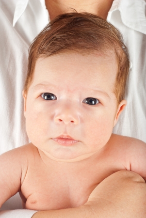 Portrait of newborn baby boy seven weeks age in his mother handsの写真素材