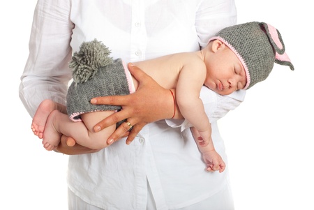 Mother hands holding sweet newborn baby in bunny costume isolated on white backgroundの写真素材