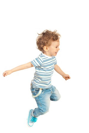 Happy toddler boy jumping isolated  on white backgroundの写真素材
