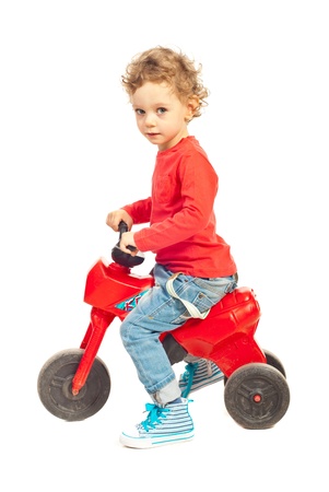 Toddler boy riding bicycle isolated on white backgroundの写真素材