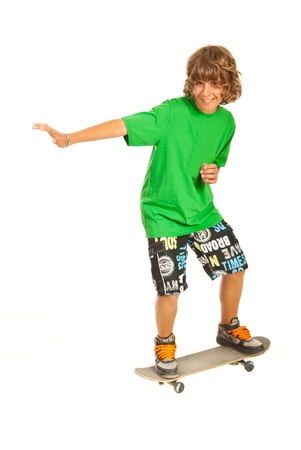 Smiling teen boy skateboarder isolated on white backgroundの写真素材