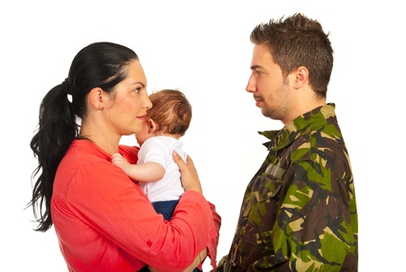 Mother holding baby boy and talking with her military husband isolated on white backgroundの写真素材