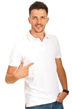 Man pointing to empty space of his t-shirt isolated on white backgroundの写真素材